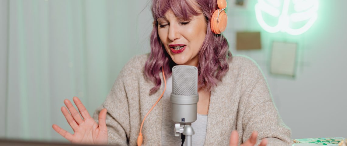 woman talking on a microphone with headphones on