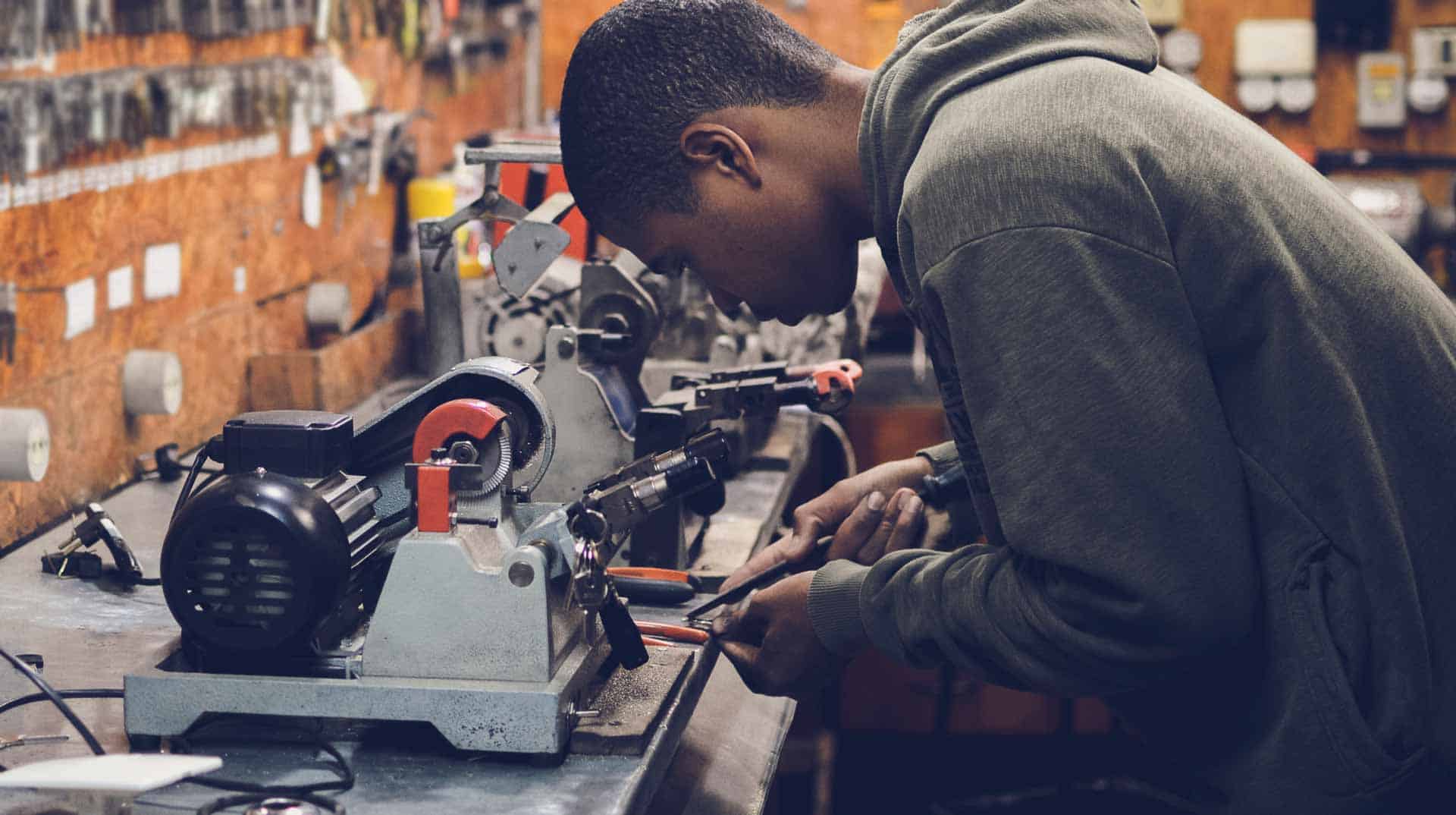 services-hero-free-img.jpg A man is a work station working on a machine