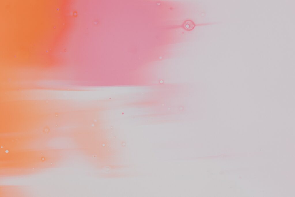 Graphic with pink and orange paint on a canvas.