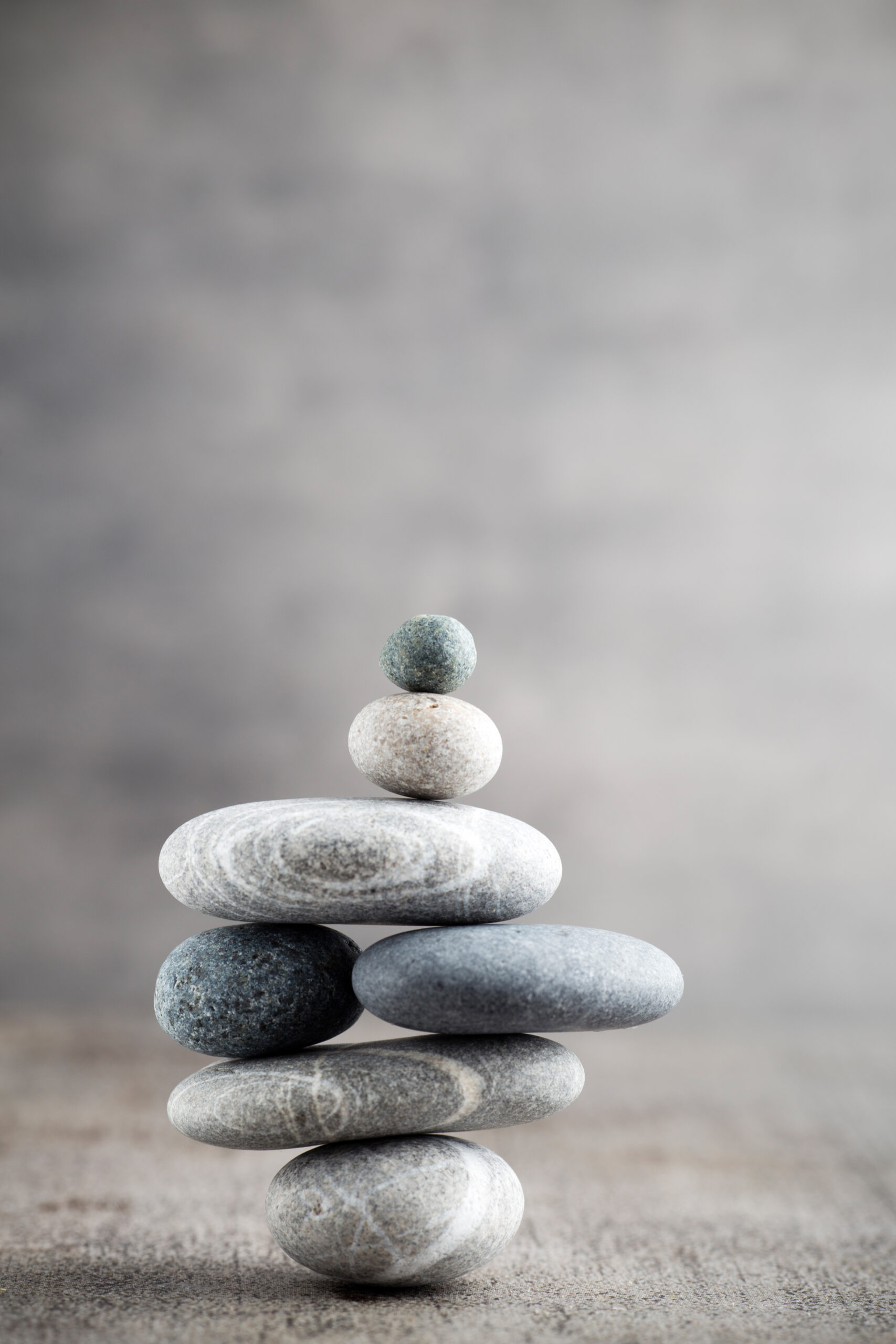 A stack of perfectly balanced rocks, representing the precision and strategy behind winning high-stakes B2B bids with video.