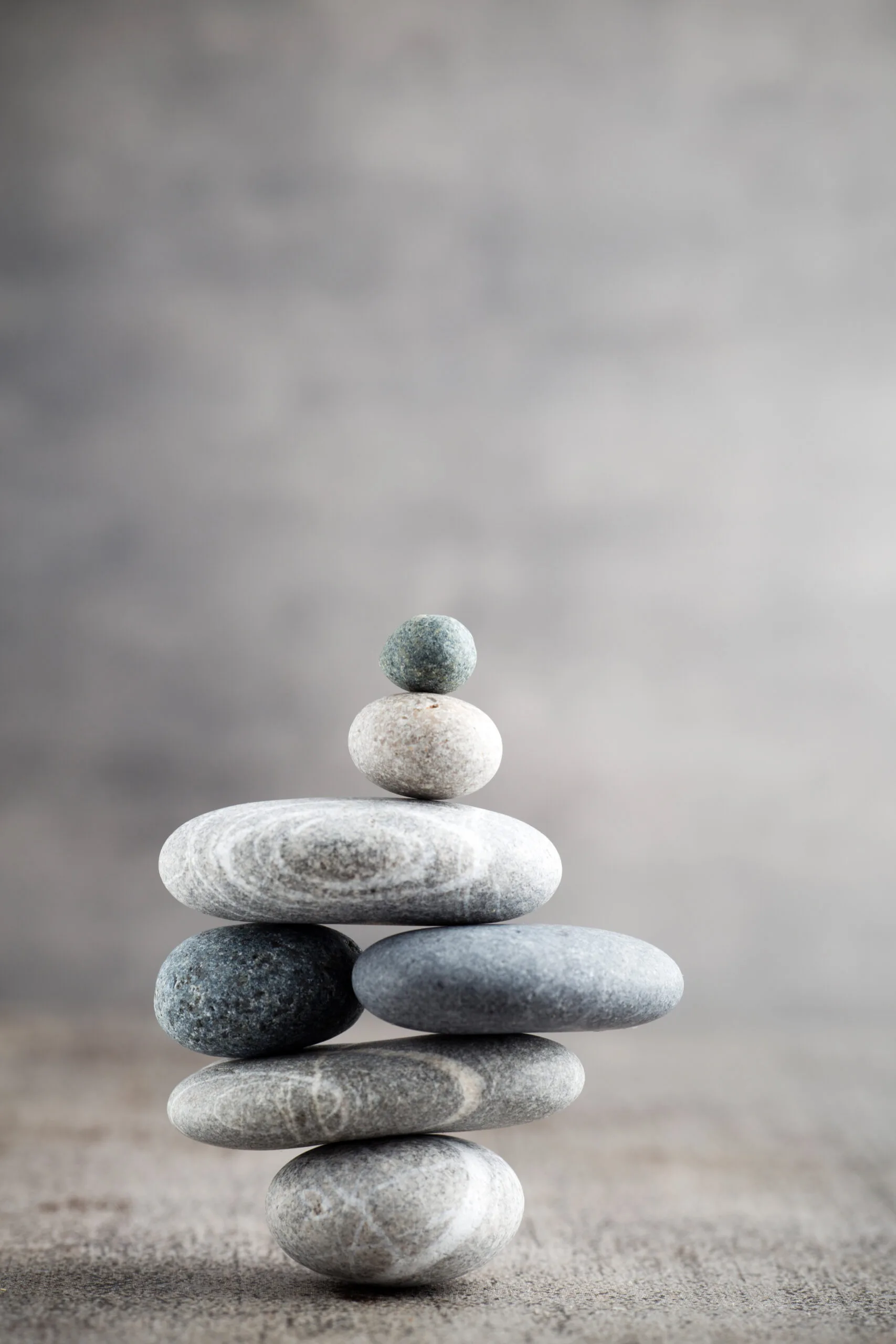 Wellness background. A stack of perfectly balanced rocks, representing the precision and strategy behind winning high-stakes B2B bids with video.
