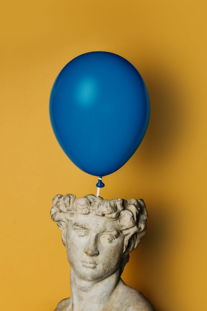 blue-balloon-with-bust-against-yellow-background-Seal Media Creative Video Production Agency