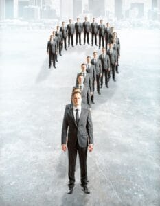 question-mark-made-of-businessmen-on-concrete-city-